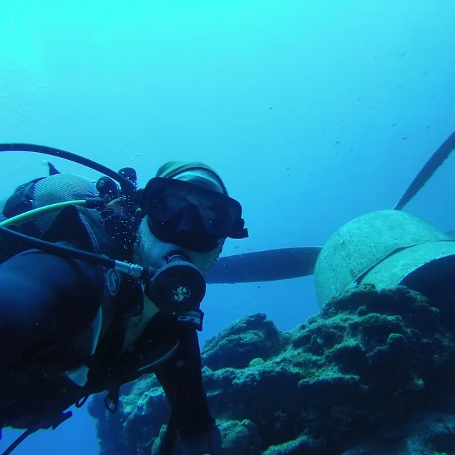 Salimcan scuba diving near a reef underwater
