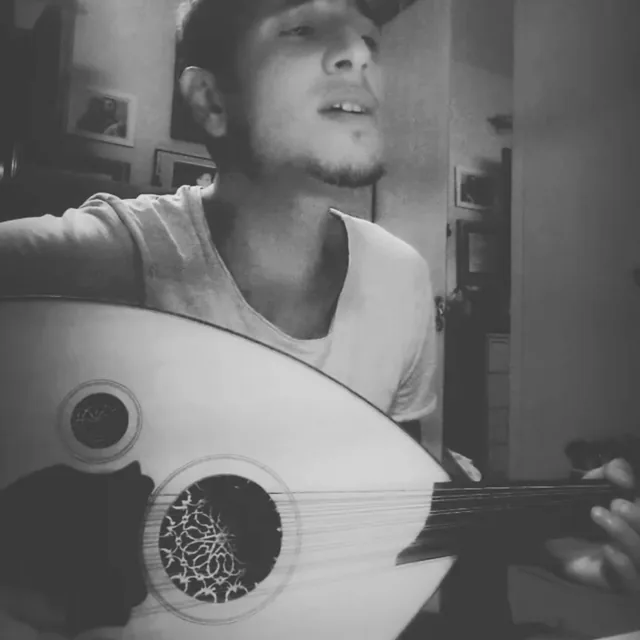 Salimcan playing the oud, a Middle Eastern stringed instrument